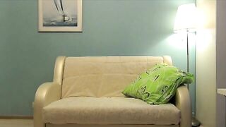 Beautiful Anja shits near the couch