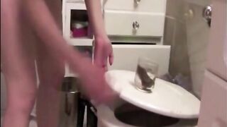 Blonde shitting in a glasses and showing her asshole