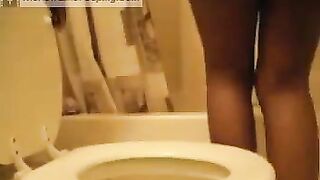 Ebony girl poops in the toilet