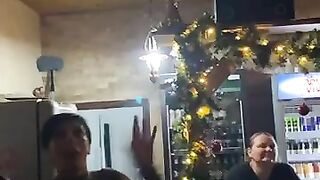 Woman pisses on the floor while eating a banana at the bar