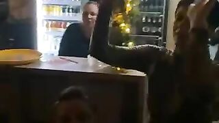 Woman pisses on the floor while eating a banana at the bar