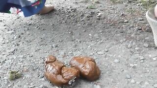 Girl does a big poop on a country lane 