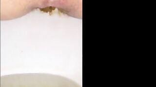 Woman shits a long piece of shit into a bowl