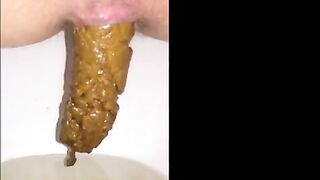 Woman shits a long piece of shit into a bowl