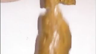 Woman shits a long piece of shit into a bowl