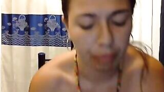Woman with a necklace plays with shit on her fingers
