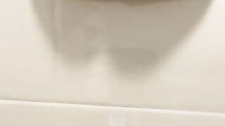 Pretty girl pisses on the toilet floor from above