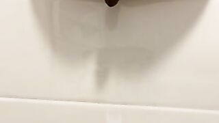 Pretty girl pisses on the toilet floor from above