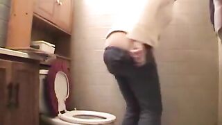Girl reads a magazine while taking a huge shit on the toilet