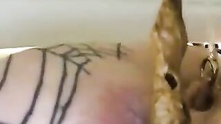 Girl with tattooed ass fucks herself with a dildo