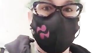 Mature woman with green hair and glasses gasps in shock