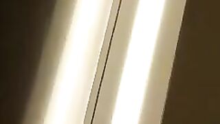 Mature woman with green hair and glasses gasps in shock