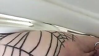 Girl in fishnet leggings squats with the ass out