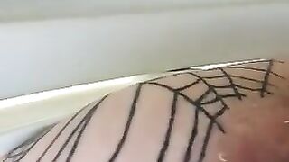 Man sticks his tongue out while wearing fishnet stockings