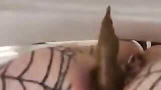 Chick in fishnets takes a big shit on the toilet