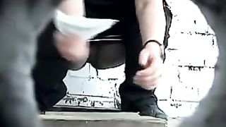 Brunette with baseball hat taking a shit