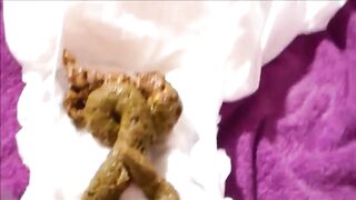 Sweet slim girl shittig in a diaper