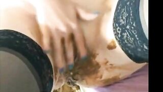 Lusty brunette milf in stockings rubbing pussy while shitting