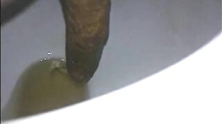 Woman shitting a long turd very slowly