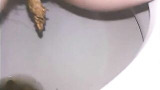 Woman shitting a long turd very slowly