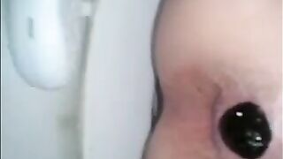 Woman shitting in the toilet real closeup