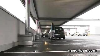 Blonde Peeing In A Supermarket Parking Lot