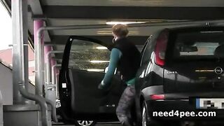 Blonde Peeing In A Supermarket Parking Lot