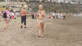 Blonde sunbathing then goes for a shit in the hills behind