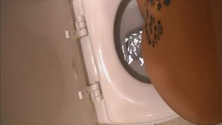 Tattooed girl pooping