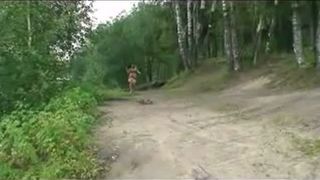 Busty girl pees on a pond