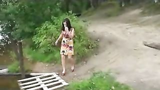 Busty girl pees on a pond